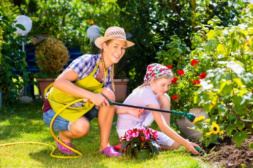 Professional gardener trimming a dense hedge
